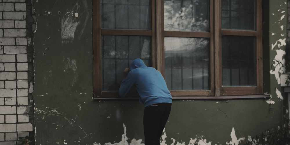 Man looking through window
